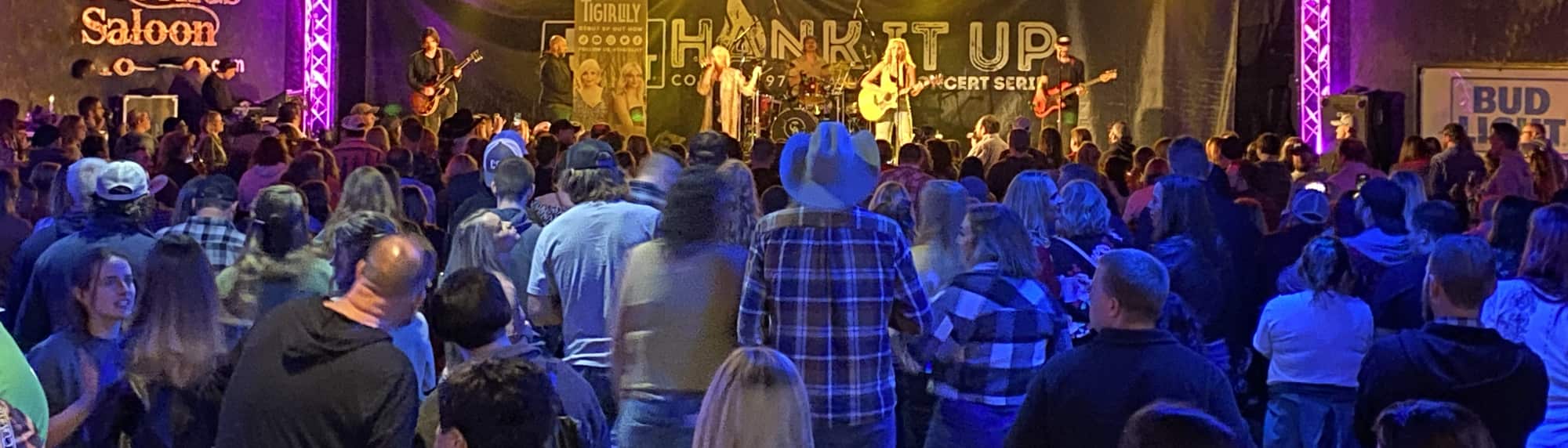 country concert with fans wearing cowboy hats Charleston